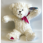 White teddy bear with a pink ribbon and heart on its paw