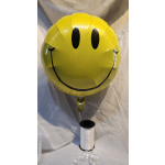 Yellow smiley-face balloon with a white ribbon spool below