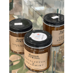 Three amber candles in glass jars with black lids