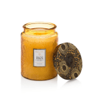 Amber glass candle jar with a patterned lid