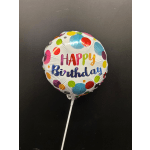 Birthday balloon with colorful polka dots on a white stick