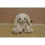White plush bunny sitting on a beige surface