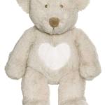 Cream teddy bear with a white heart on its chest