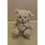 Cream-colored teddy bear with a satin ribbon bow