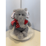 Gray plush elephant with red heart ribbon on a round base