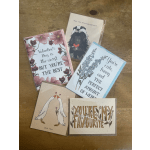 Assorted floral greeting cards with Valentine messages on a wooden surface