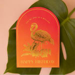 Birthday card with a flamingo illustration on a large green leaf
