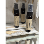 Three small spray bottles labeled peppermint sit on a shelf.