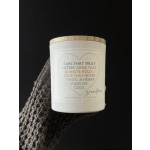 White candle jar with a wooden lid and a heart-shaped label