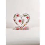 Heart-shaped floral resin ornament on a clear base