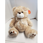Plush teddy bear with a ribbon bow and paw-print accents