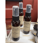 Three spray bottles of bourbon chestnut hand sanitizer on a tray