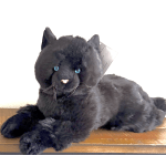 Black plush cat with blue eyes lying on a wooden surface