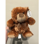 Brown plush teddy bear with a ribbon around its neck