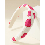 Beaded headband with pink heart patterns on a white band