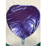 Purple heart-shaped foil balloon on a light wood surface