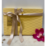 Godiva chocolate gift box tied with a satin ribbon and a pink orchid bloom