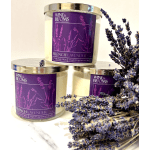 Three lavender-scented candles with dried lavender sprigs