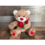 Tan teddy bear plush with red heart accents holding a single red fabric rose