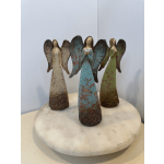 Three angel figurines standing on a round marble base