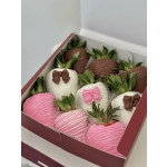 Box of chocolate-covered strawberries decorated with pink, white, and brown drizzles