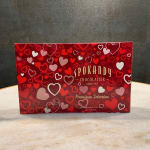 Red heart-patterned chocolate box on a countertop