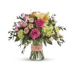 Bouquet of pink and peach flowers in a glass vase