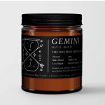 Black-labeled Gemini candle in an amber glass jar with a black lid