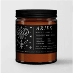 Amber candle in a black-lidded jar with an Aries label