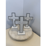 Three decorative cross signs on a round marble base