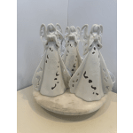 Three white ceramic angel figurines on a round base