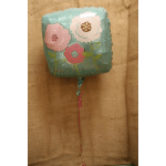 Square birthday balloon with pastel flower graphics and a hanging ribbon