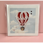 Greeting card with a red hot air balloon and two hearts