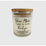 Soy wax candle in a glass jar with a bamboo lid and printed message