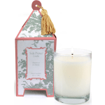 Lit white candle beside a decorative boxed candle with tassel