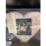 Pink knitted heart-shaped gift in a box with a comfort message tag