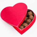 Heart-shaped box of assorted chocolates with a red lid
