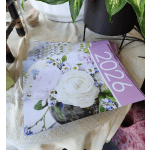 Stack of floral catalog cards with a white flower arrangement on the cover
