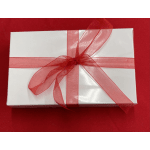 White gift box tied with a red ribbon bow