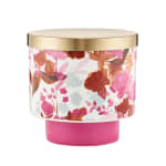 Floral-printed candle jar with gold lid and bright pink base