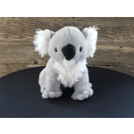Plush koala toy sitting on a black surface