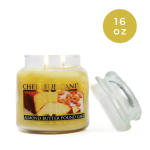 Yellow candle jar labeled almond butter pound cake with a lid beside it