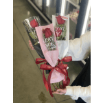 Three wrapped red rose bouquets with pink, black, and white sleeves