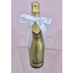 Gold bottle of sparkling wine tied with a white ribbon