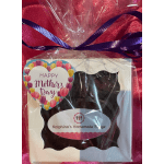 Wrapped gift box with a Mother's Day label and purple ribbon