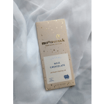 Milk chocolate bar in beige packaging on white fabric