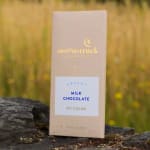 Milk chocolate bar in a beige box with gold lettering