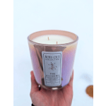 Pink glass candle jar with a white wax candle