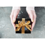 Hands holding a black gift box tied with a gold ribbon