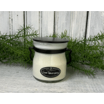 White jar candle with black lid and handles